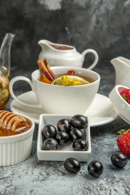 暗い表面の朝の食べ物の朝食にオリーブと蜂蜜とお茶の正面図