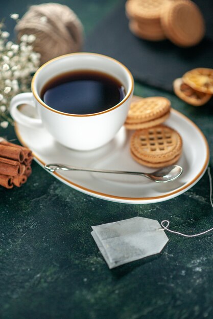 front view cup of tea with sweet biscuits on dark surface bread drink ceremony sweet breakfast morning photo sugar cake glass color