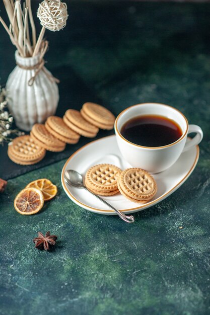 front view cup of tea with sweet biscuits in white plate on dark surface bread drink ceremony breakfast morning glass sugar photo color