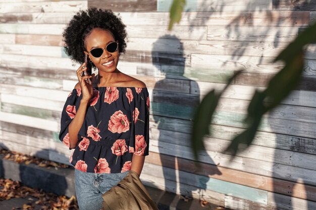 Front view curly haired woman talking on the phone