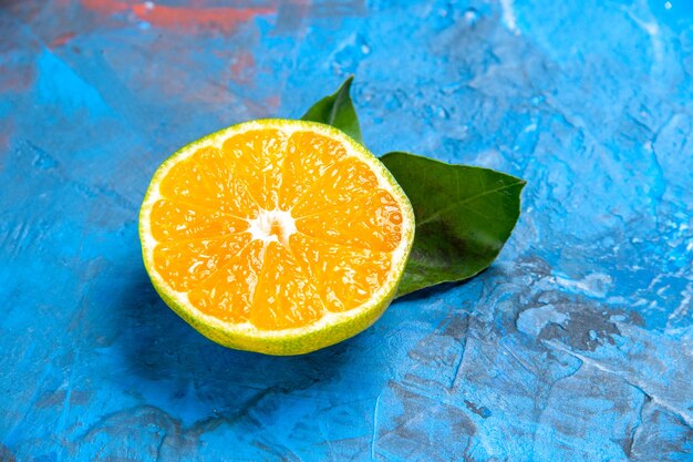 front view cut orange on blue background free space