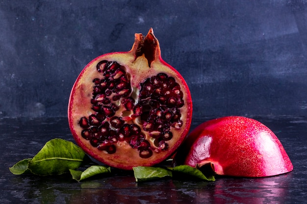 Front view cut pomegranate on a black background