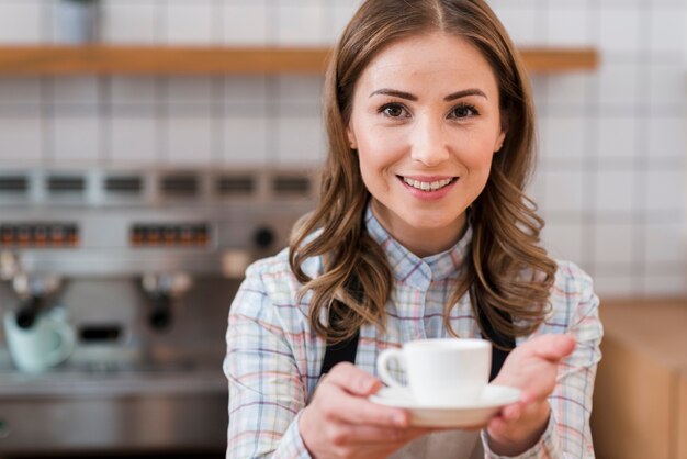 Front view of cute barista with coffee