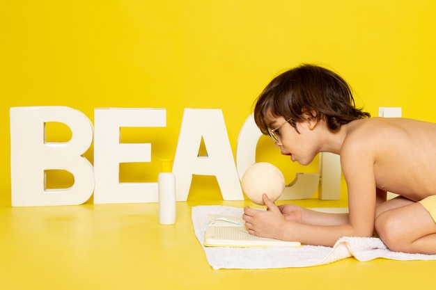 front view cute boy along with beach word on yellow