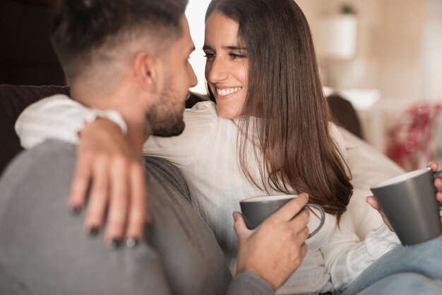 Front view cute couple drinking coffee