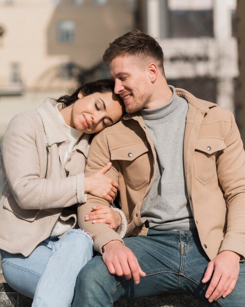 Front view of cute couple embraced outside