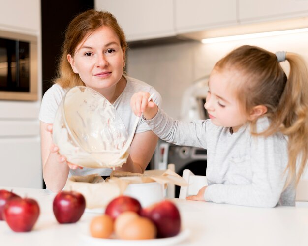 Front view of cute family cooking together