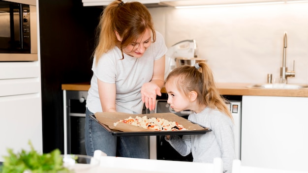 Free photo front view of cute family cooking together