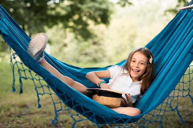 Front view of cute girl in hammock