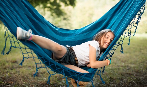 Front view of cute girl in hammock