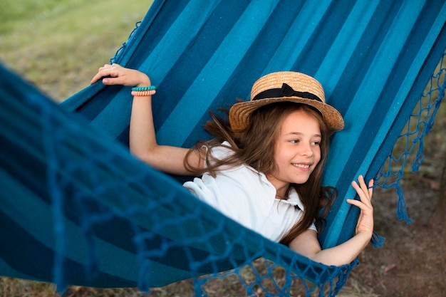 Front view of cute girl in hammock