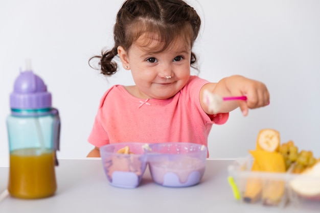 Free photo front view cute girl offering food