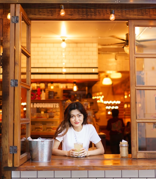 Free photo front view of cute japanese girl drinking lemonade