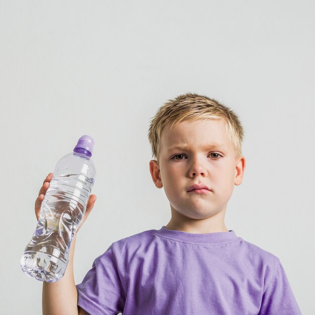 Front view cute kid with a water bottle