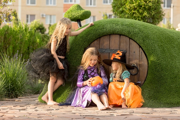 Front view of cute little girls with halloween costumes