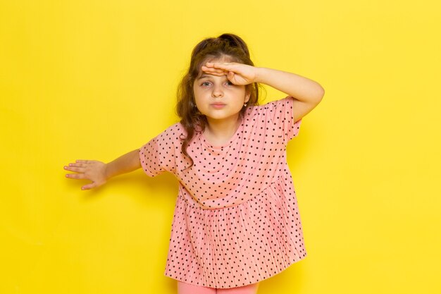 Free photo a front view cute little kid in pink dress looking into the distance