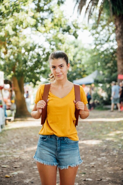 Front view of cute traveler with backpack