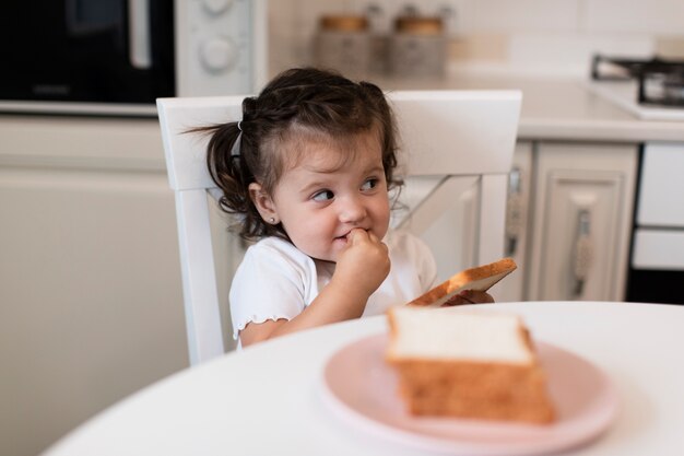 Free photo front view cute young girl on a chair