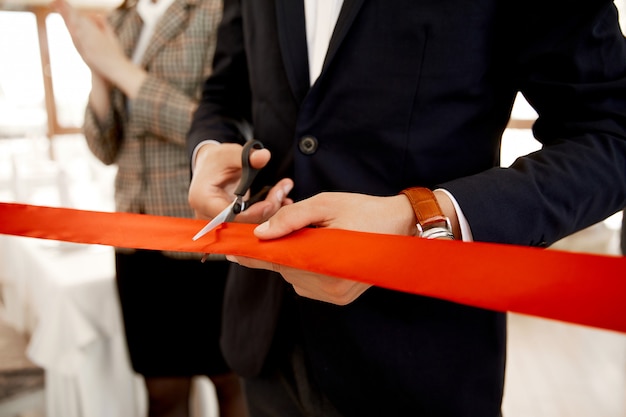 Free photo front view of the cutting the red ribbon on the grand opening of the building