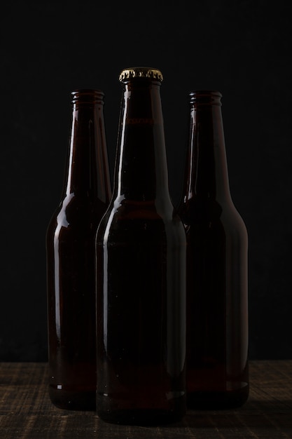 Free photo front view dark colored bottles of beer