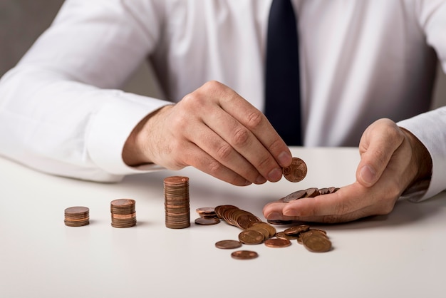 Front view of defocused businessman with coins