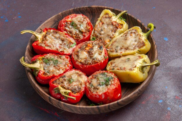 Front view delicious bell-peppers cooked dish with meat on dark background dinner dish meat bake food salt