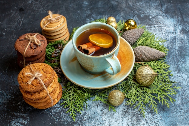 Front view delicious biscuits with cup of tea on light surface