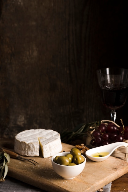 Front view delicious buffet with cheese on wooden board