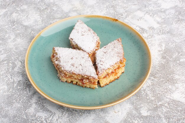 Front view delicious cake slices with sugar powder inside plate on the table, cake biscuit sugar sweet pastry bake