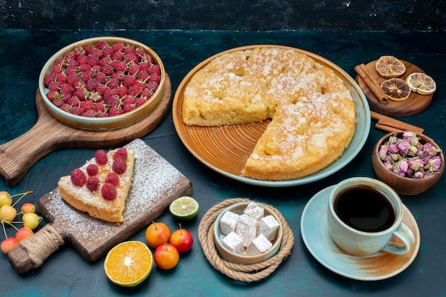 Front view delicious cake with tea and fruits on the dark-blue desk pie cake sweet biscuit sugar