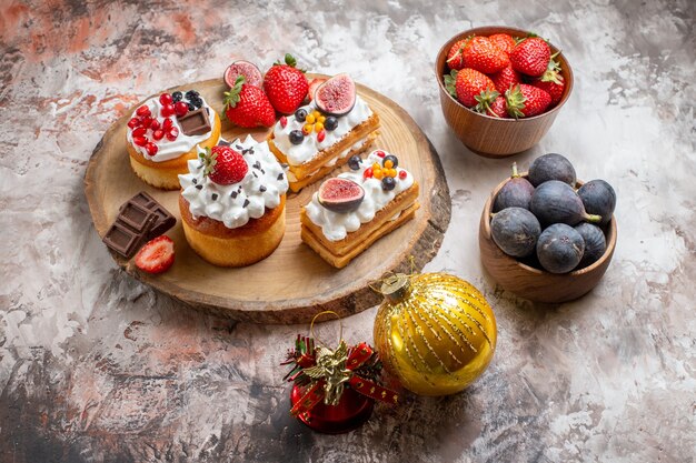 Front view delicious cakes with fresh fruits on light background christmas cake dessert color biscuits