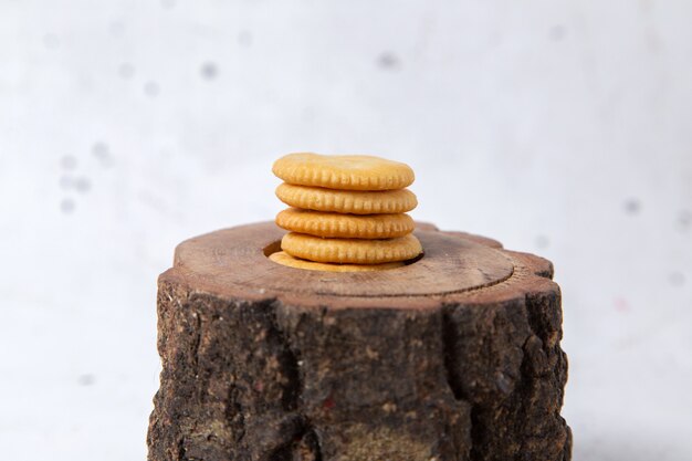 Front view of delicious cookies round formed on the brown wooden desk and whtie surface