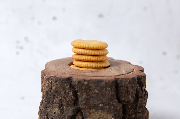 Front view of delicious cookies round formed on the brown wooden desk and whtie surface