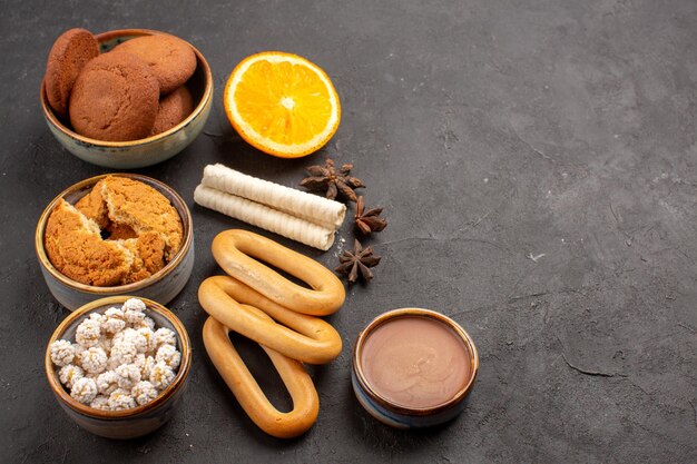 Front view delicious cookies with crackers on dark background cookie biscuit sugar dessert sweet cake