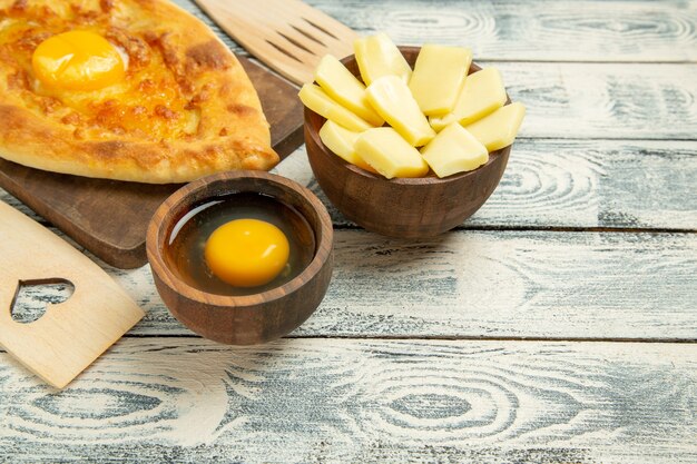 Front view delicious egg bread baked on a rustic desk