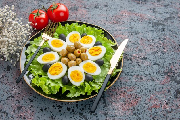 front view delicious egg salad with tomatoes and olives on light background