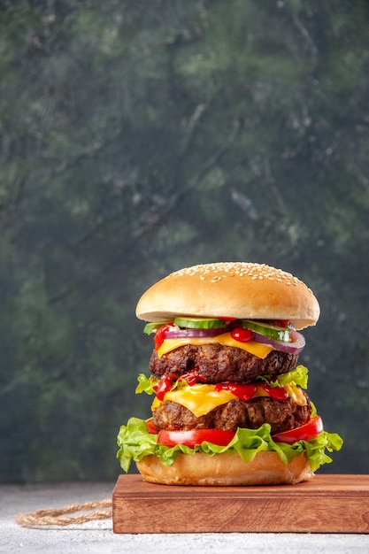 Front view of delicious homemade sandwich on wooden board on blurred surface