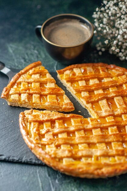 front view delicious kumquat pie with sliced one piece on dark blue surface oven dessert sweet dough biscuit color tea cake cookie