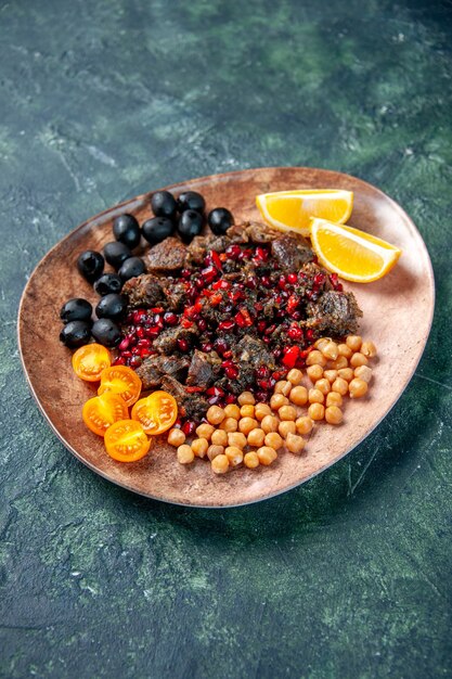 front view delicious meat slices fried with beans grapes and lemon slices inside plate on dark background