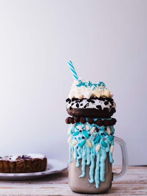 Front view of delicious milkshake on wooden table