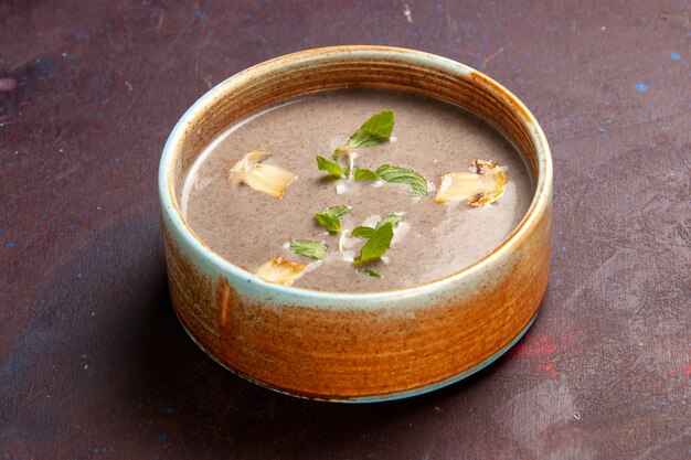 Front view delicious mushroom soup inside plate on dark space