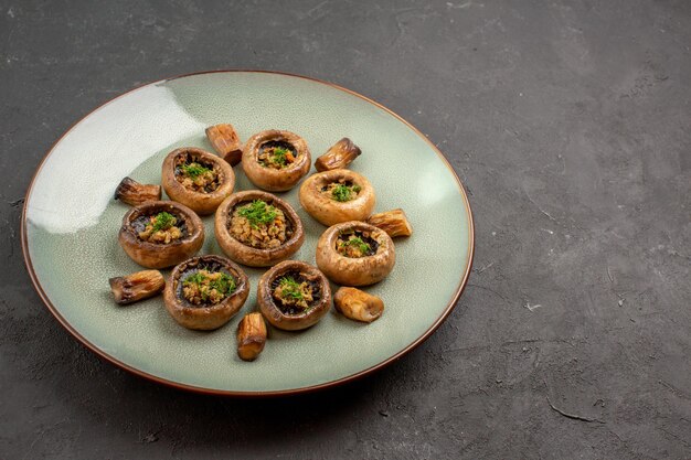 Front view delicious mushrooms meal cooked with greens on dark background dish dinner meal cooking mushrooms