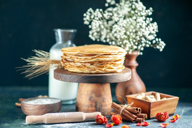 Front view delicious pancakes with milk on dark blue dessert breakfast honey cake milk sweet morning pie