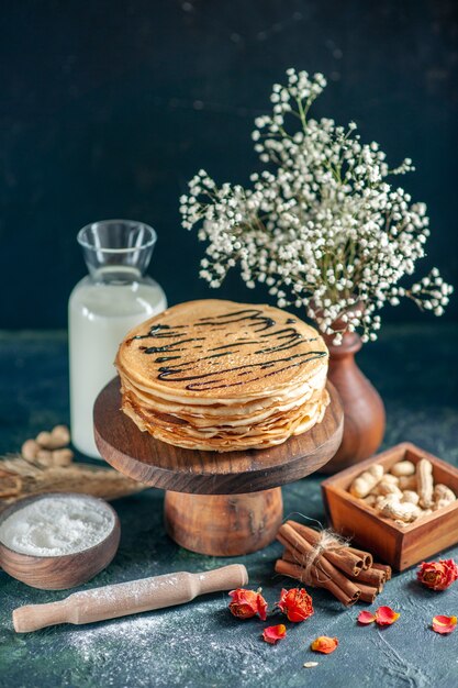 Front view delicious pancakes with milk on dark blue milk dessert breakfast honey sweet morning pie cake