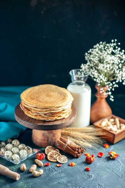 Front view delicious pancakes with milk on a dark breakfast honey cake pie morning tea dessert milk sweet