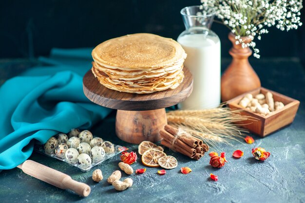 Front view delicious pancakes with milk on dark breakfast honey cake pie morning tea dessert milk sweet