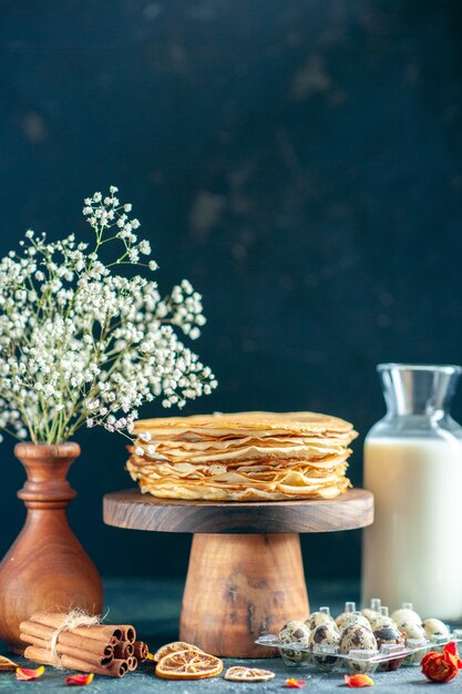 Front view delicious pancakes on wooden desk and dark breakfast cake pie sweet honey morning tea dessert milk