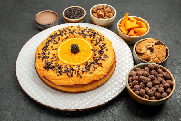 어두운 배경 차 비스킷 과일 디저트 파이 케이크에 오렌지 조각이 있는 전면 보기 맛있는 파이
