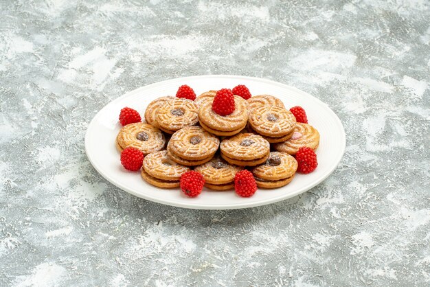 Front view delicious round biscuits with raspberry confitures on white space