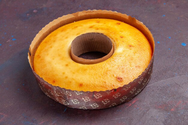 Front view delicious round cake perfect sweet pie for tea on dark background tea sweet pie sugar dough cake